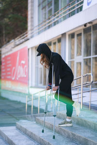 Low section of woman walking on street