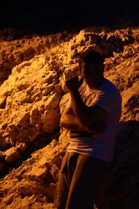 Man leaning on rock outdoors