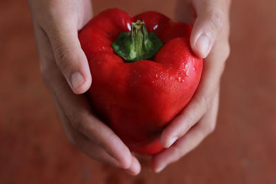 Close-up of hand holding strawberry