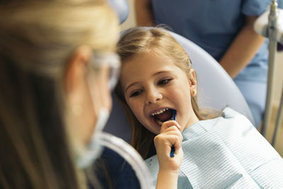 Dentist examining patient mouth in medical clinic
