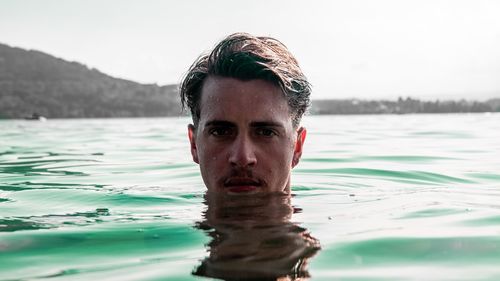 Portrait of young man swimming in pool