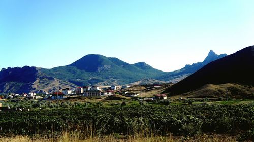 Scenic view of mountains against blue sky