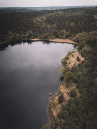 High angle view of lake and trees against sky