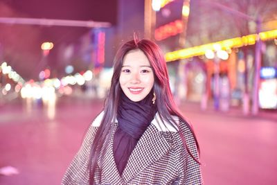 Portrait of young woman standing outdoors