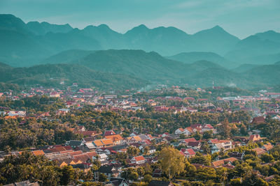 High angle view of townscape and mountains against sky