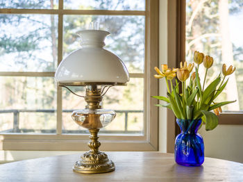 Close-up of vase on table against window