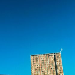 Low angle view of building against clear blue sky