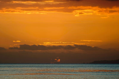 Scenic view of sea against orange sky