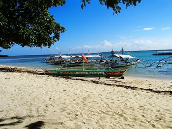 Scenic view of beach against cloudy sky