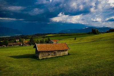 A hut in the allgäu with a thundercloud in the background