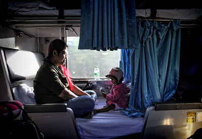 Couple looking at while sitting on seat