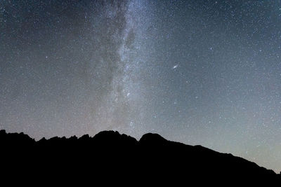 Milky way a and sky full of stars above mountains silhouette , slovakia, europe