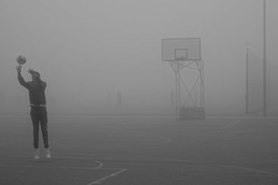 Low angle view of basketball hoop in foggy weather