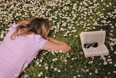 High angle view of woman lying down on plant