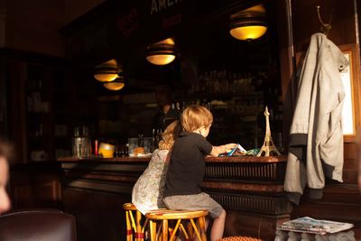 Rear view of woman sitting on chair