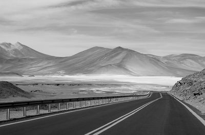 Monochrome empty road to the amazing highland salt lakes in northern chile, south america