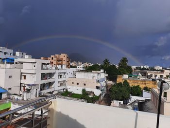 High angle view of rainbow over buildings in town
