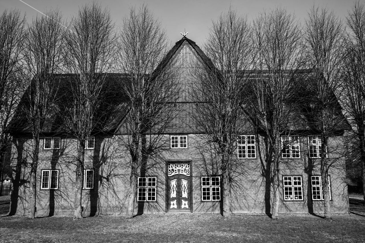 VIEW OF CHURCH WITH TREES IN BACKGROUND