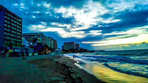 View of beach against cloudy sky