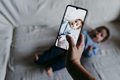 Midsection of man using mobile phone