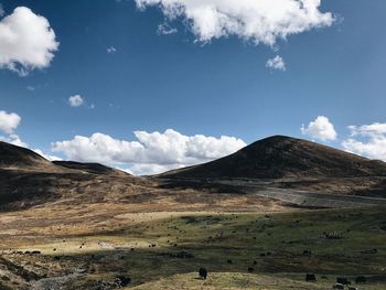 Scenic view of field and mountains against sky