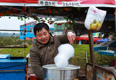 Portrait of woman at market stall