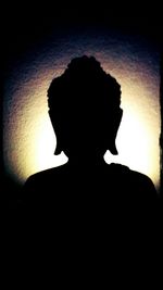 Silhouette woman standing against sky at night