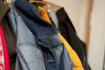 Close-up of clothes hanging in closet