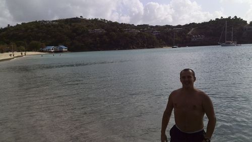 Man standing on beach against sky