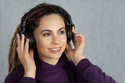 Portrait of a smiling young woman using mobile phone
