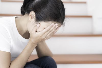 Midsection of woman sitting at home