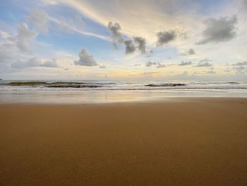 Scenic view of beach against sky during sunset