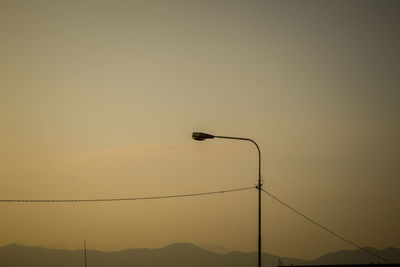 Low angle view of silhouette street light against sky during sunset