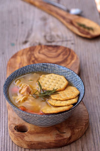 High angle view of soup with crackers on wooden table