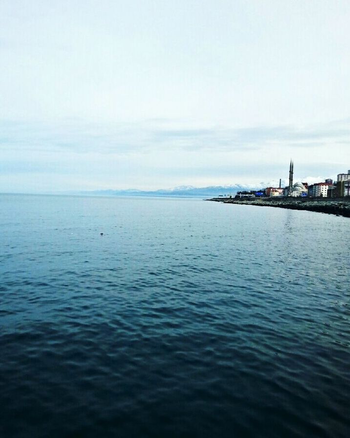 sea, water, sky, tranquil scene, waterfront, horizon over water, scenics, tranquility, beauty in nature, built structure, nature, building exterior, rippled, architecture, cloud - sky, idyllic, beach, cloud, calm, copy space