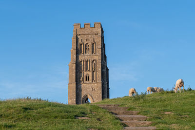 Castle on field against sky