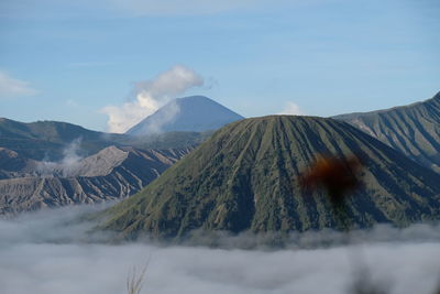 Amazing scene at bromo, indonesia with smoky volcano and dancing clouds.