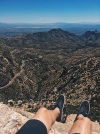 Low section of person legs against mountain range