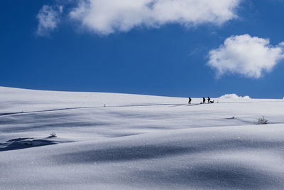 Scenic view of snow covered landscape against sky