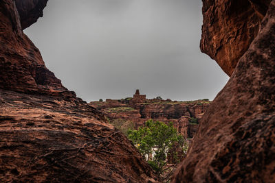 Low angle view of rock formations against sky