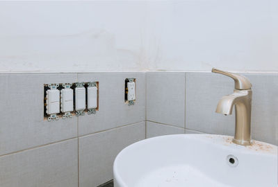 Close-up of faucet in bathroom at home