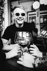 Portrait of smiling man wearing sunglasses at restaurant