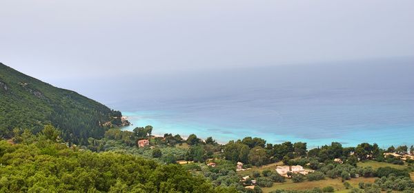 High angle view of trees and sea against sky