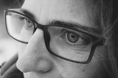 Close-up of woman looking away while wearing eyeglasses