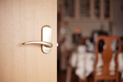 Close-up of door with dining room in background