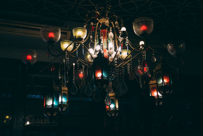 Low angle view of illuminated lanterns hanging at night