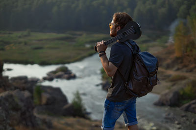 Rear view of a man with woman standing on land