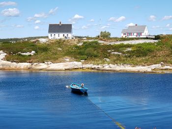 Scenic view of sea against buildings in city