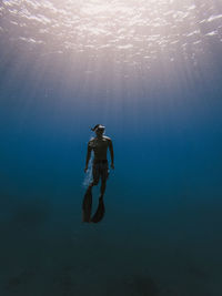 Full length of man swimming under sea