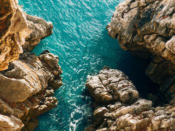 High angle view of rocks in sea